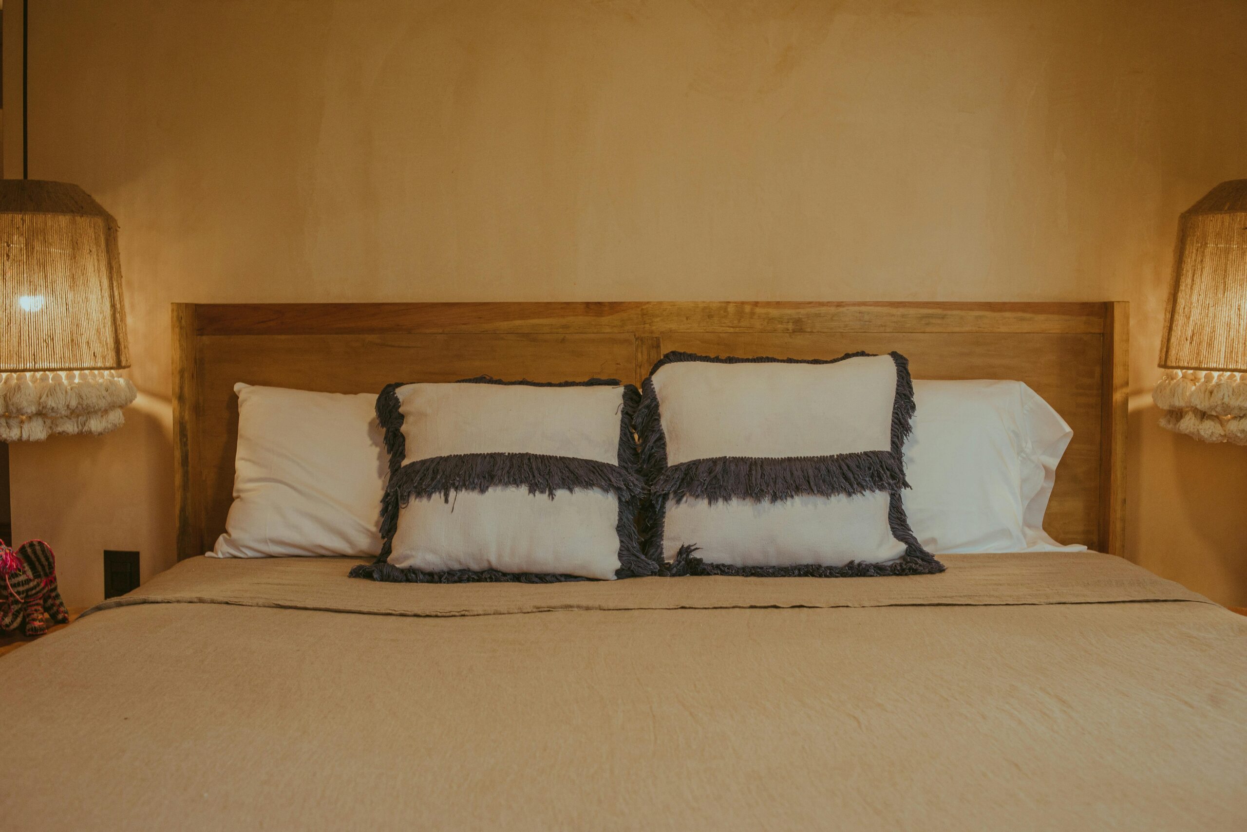 A serene and stylish bedroom setup featuring rustic decor and elegant lighting for a cozy atmosphere.
